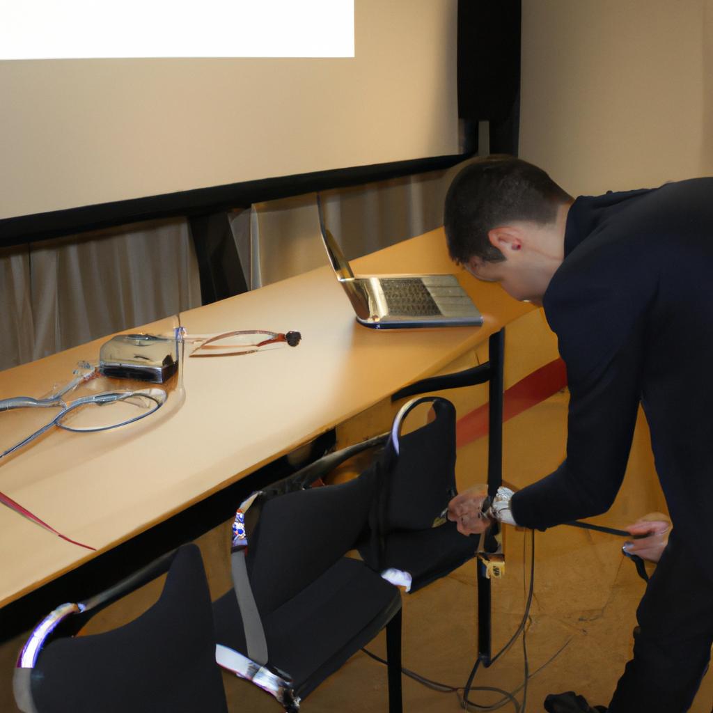 Person setting up conference equipment